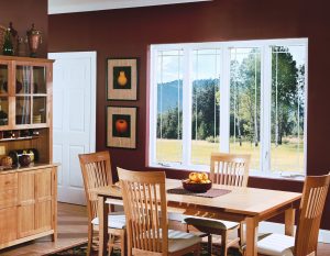 Dining room with beautiful wood furniture, burgundy walls, and windows overlooking rolling hills