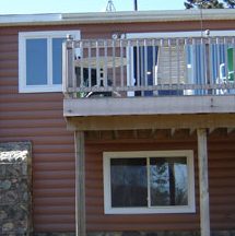 Side of home with gorgeous metal siding and slider windows